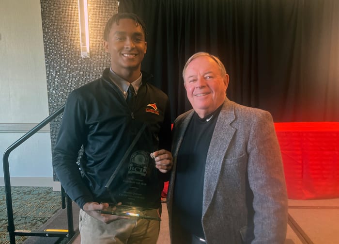 Calvert Hall's Brendan Johnson showcases his 2024 BCL Player of the Year award while posing with BCL Commissioner Jack Degele.
